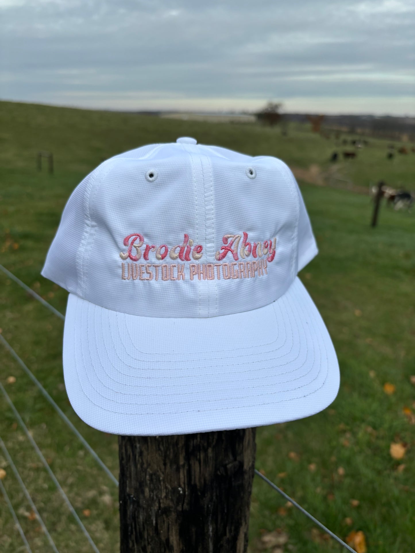 White hat with multicolor pink stitch
